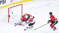 Chicago Blackhawks goaltender Spencer Knight (30) defends against New Jersey Devils center Jack Hughes (86) during the second period at United Center.