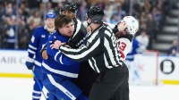 oronto Maple Leafs left wing Matthew Knies (23) fights with New Jersey Devils center Nico Hischier (13) during the third period at Scotiabank Arena.