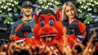 New Jersey Devils mascot in between Paul Skenes and Olivia Livvy Dunne and Christmas mistletoe above them.