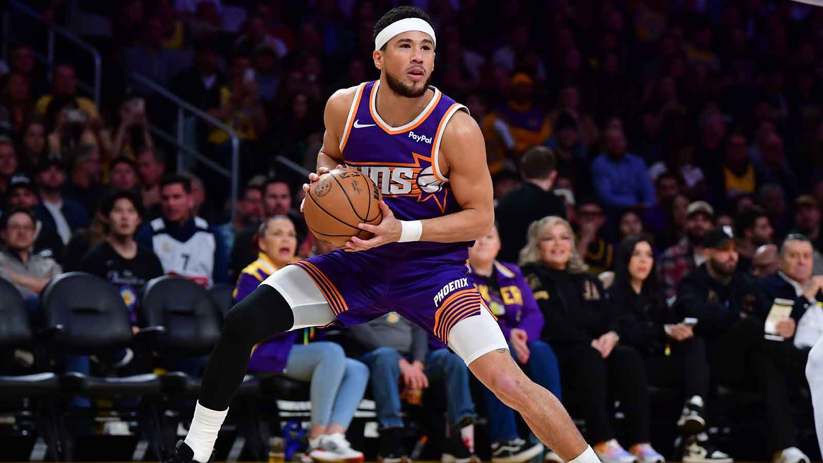 Phoenix Suns guard Devin Booker (1) controls the ball against the against the Los Angeles Lakers during the first half at Crypto.com Arena.