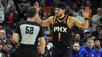 Phoenix Suns guard Devin Booker (1) talks to an official in the first half against the New York Knicks at Footprint Center.