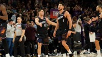 Phoenix Suns guard Devin Booker (1) and guard Collin Gillespie (12) react after the Sun take the lead late in the second half of a game against the Los Angeles Lakers at Mortgage Matchup Center.