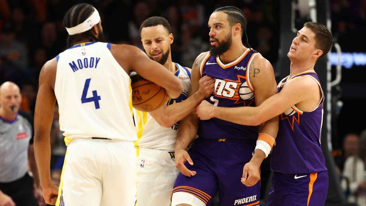 Phoenix Suns guard Collin Gillespie (right) holds back forward Dillon Brooks (3) from Golden State Warriors guard Moses Moody (4) with the help of guard Stephen Curry (30) in the second half at Mortgage Matchup Center.