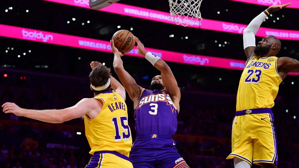 Phoenix Suns forward Dillon Brooks (3) moves to the basket against Los Angeles Lakers guard Austin Reaves (15) and forward LeBron James (23) during the first half at Crypto.com Arena.