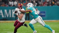 Washington Commanders tight end Colson Yankoff (80) carries the ball defended by Miami Dolphins safety Minkah Fitzpatrick (29) in the first quarterduring the 2025 NFL Madrid Game at Santiago Bernabeu Stadium.