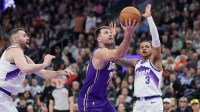 Los Angeles Lakers forward/guard Luka Doncic (77) drives past Utah Jazz forward/center Kevin Love (42) during the first quarter at Delta Center.