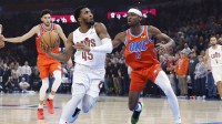Cleveland Cavaliers guard Donovan Mitchell (45) drives to the basket against Oklahoma City Thunder guard Shai Gilgeous-Alexander (2) during the first quarter at Paycom Center.