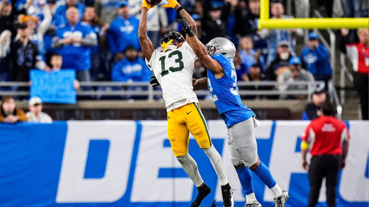 Green Bay Packers wide receiver Dontayvion Wicks (13) makes a catch against Detroit Lions safety Brian Branch (32) during the second half at Ford Field in Detroit on Thursday, Nov. 27, 2025.