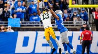 Green Bay Packers wide receiver Dontayvion Wicks (13) makes a catch against Detroit Lions safety Brian Branch (32) during the second half at Ford Field in Detroit on Thursday, Nov. 27, 2025.