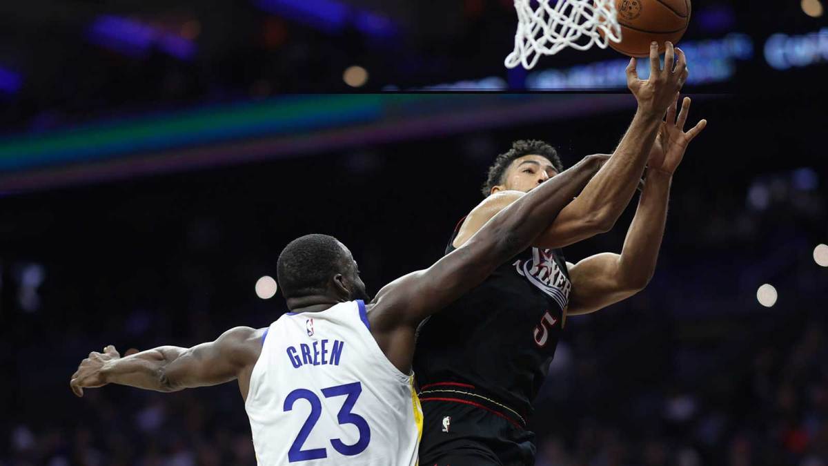 Philadelphia 76ers guard Quentin Grimes (5) is fouled by Golden State Warriors forward Draymond Green (23) while driving for a shot during the second quarter at Xfinity Mobile Arena.