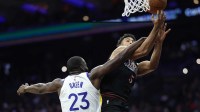 Philadelphia 76ers guard Quentin Grimes (5) is fouled by Golden State Warriors forward Draymond Green (23) while driving for a shot during the second quarter at Xfinity Mobile Arena.