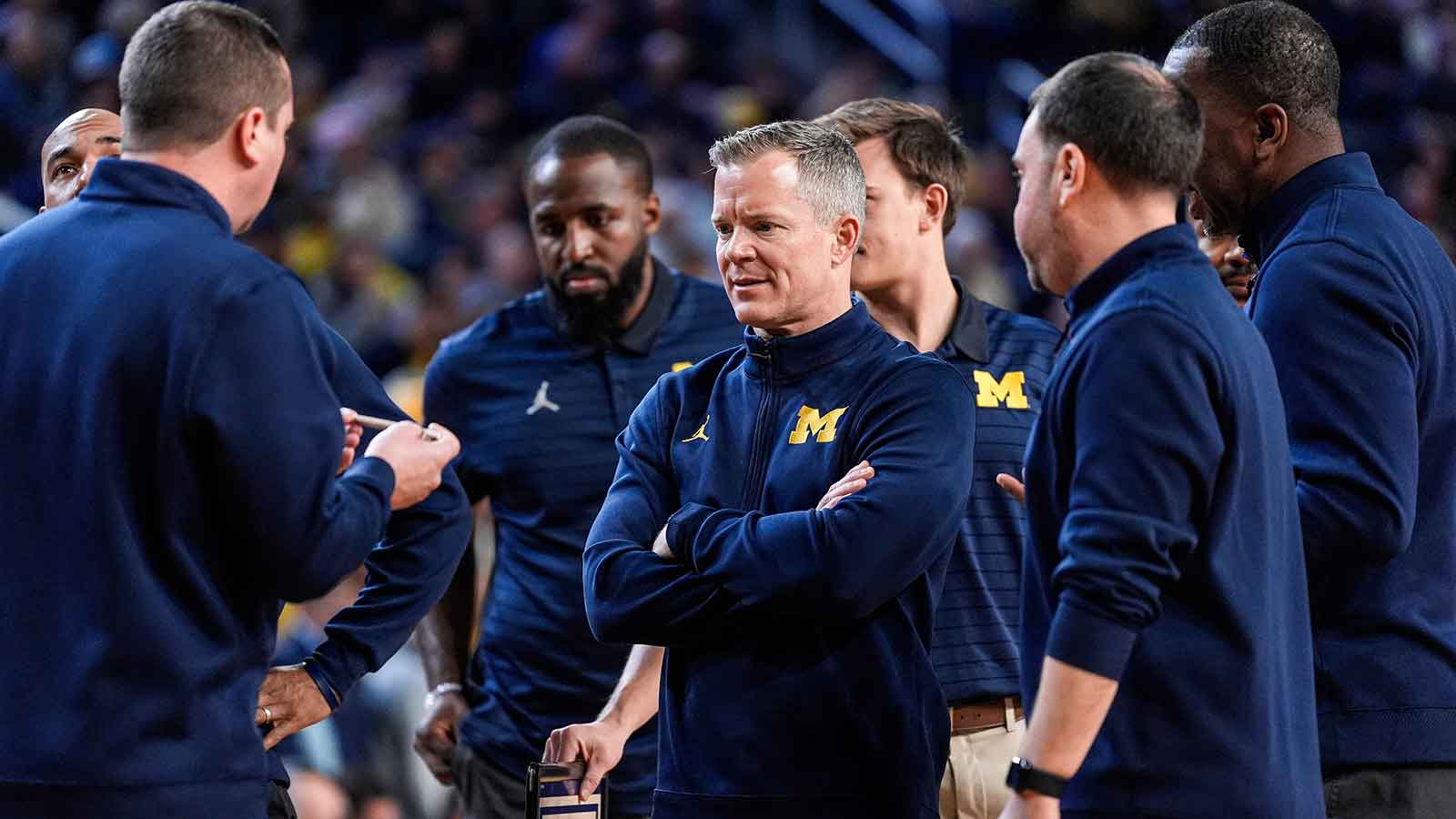 Michigan head coach Dusty May, center, talks to the assistant coaches during a timeout against Villanova during the second half at the Crisler Center in Ann Arbor, Tuesday, Dec. 9, 2025.