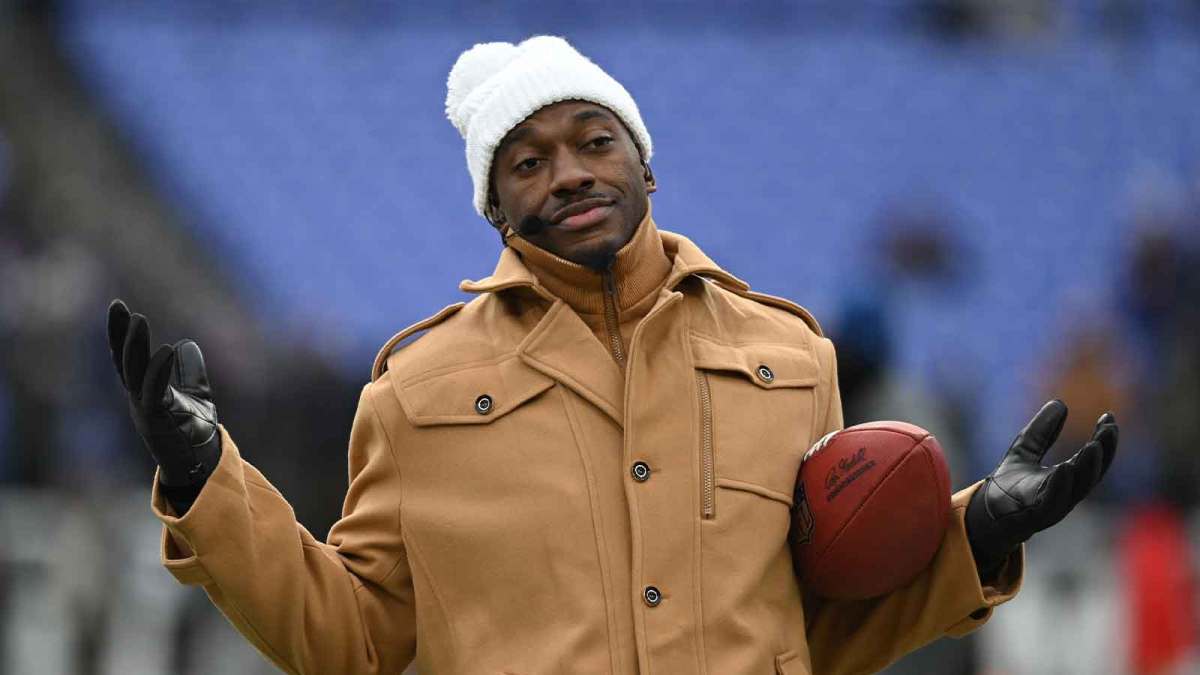 ESPN college football and NFL analyst Robert Griffin III reacts on the sidelines before a 2024 AFC divisional round game between the Houston Texans and the Baltimore Ravens at M&T Bank Stadium.