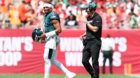 Philadelphia Eagles offensive coach Kevin Patullo communicates with quarterback Jalen Hurts (1) during a timeout in the second quarter against the Tampa Bay Buccaneers at Raymond James Stadium.