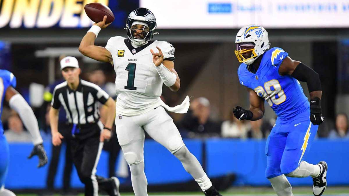 Philadelphia Eagles quarterback Jalen Hurts (1) passes against Los Angeles Chargers linebacker Odafe Oweh (98) in the second half at SoFi Stadium.