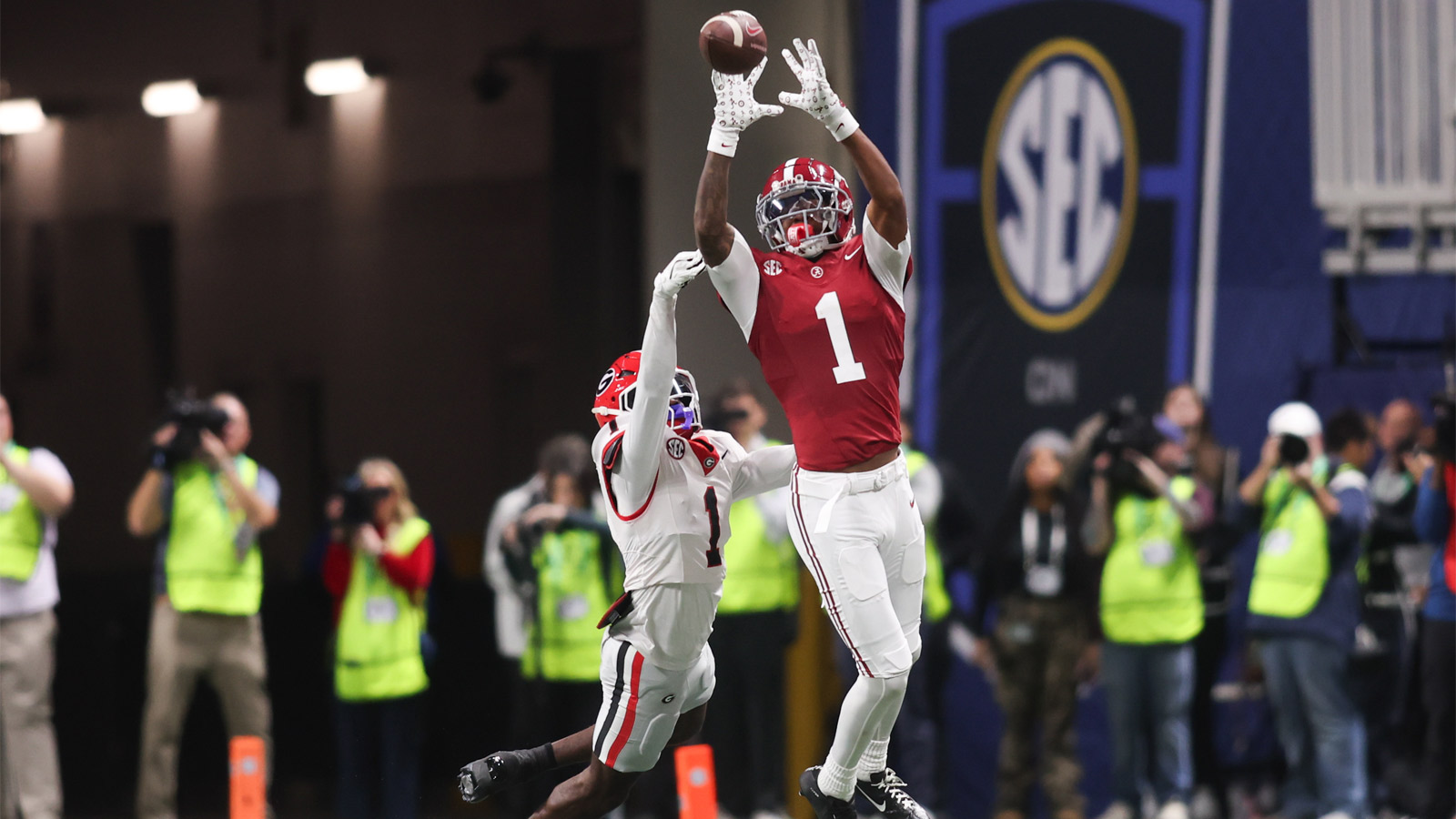 Alabama Crimson Tide wide receiver Isaiah Horton (1) attempts to make a catch as Georgia Bulldogs defensive back Ellis Robinson IV (1) defends during the second quarter during the 2025 SEC Championship game at Mercedes-Benz Stadium.