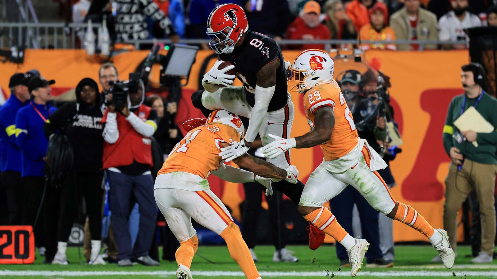 Atlanta Falcons tight end Kyle Pitts Sr. (8) is tackled by Tampa Bay Buccaneers safeties Antoine Winfield Jr. (31) and Christian Izien (29) after catching a pass during the second quarter at Raymond James Stadium.