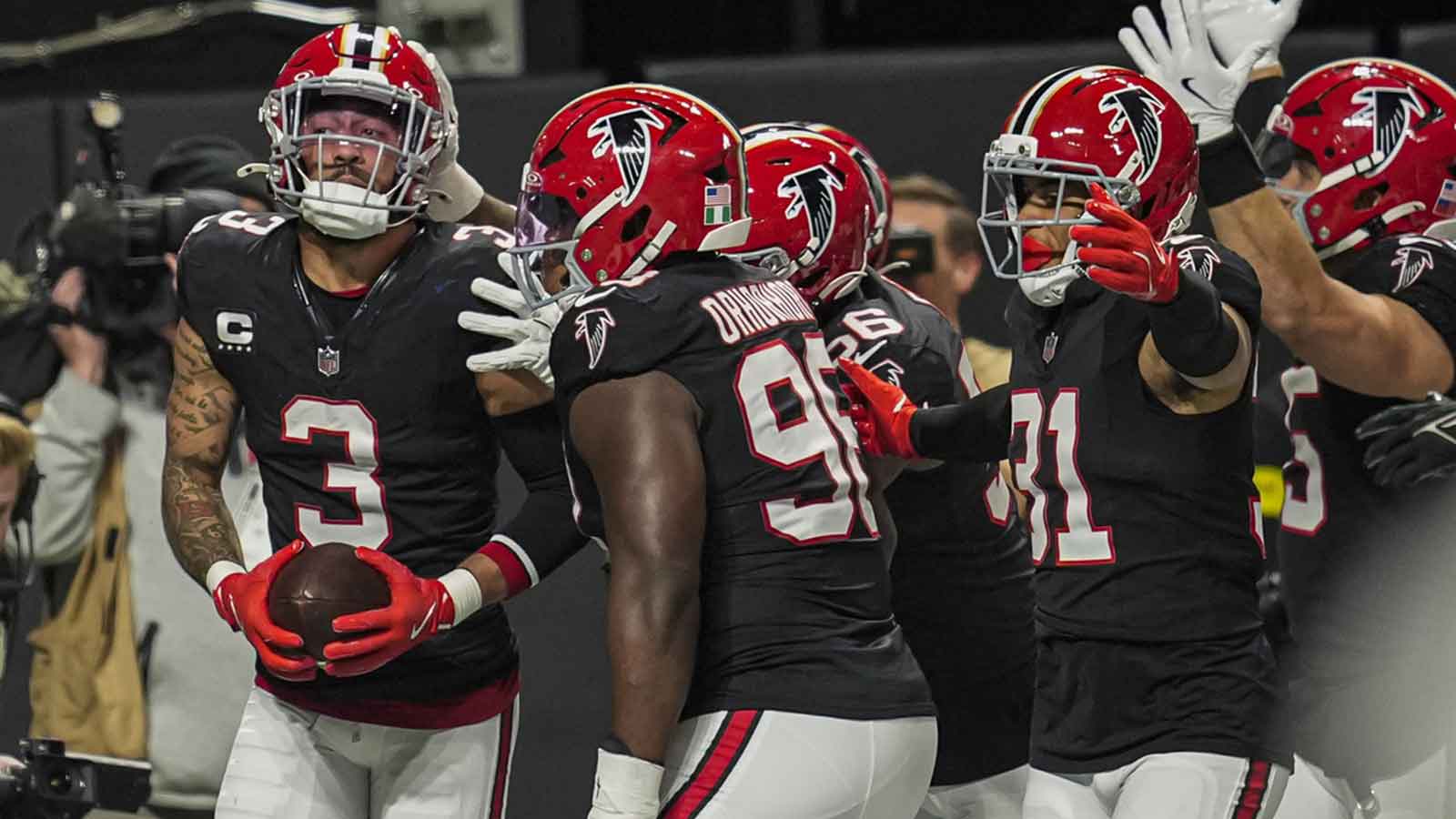 Atlanta Falcons safety Jessie Bates III (3) reacts with teammates after returning an intercepted pass for a touchdown against the Los Angeles Rams during the first half at Mercedes-Benz Stadium.