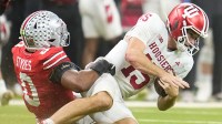 Ohio State Buckeyes linebacker Sonny Styles (0) hits Indiana Hoosiers quarterback Fernando Mendoza (15) during the first half of the Big Ten Conference championship game at Lucas Oil Stadium in Indianapolis on Dec. 6, 2025.