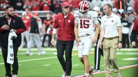 Indiana Hoosiers quarterback Fernando Mendoza (15) walks off the field after an apparent injury in the first quarter against the Ohio State Buckeyes during the 2025 Big Ten championship game at Lucas Oil Stadium.