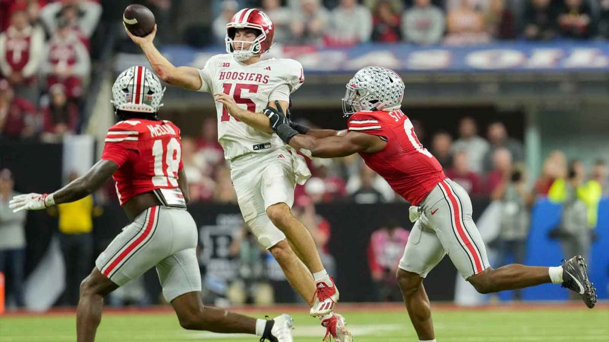 Indiana Hoosiers quarterback Fernando Mendoza (15) looks to throw as Ohio State Buckeyes safety Jaylen McClain (18) and Ohio State Buckeyes linebacker Sonny Styles (0) move in Saturday, Dec. 6, 2025, during the Big Ten football championship at Lucas Oil Stadium in Indianapolis.