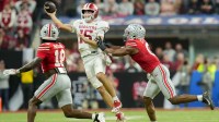 Indiana Hoosiers quarterback Fernando Mendoza (15) looks to throw as Ohio State Buckeyes safety Jaylen McClain (18) and Ohio State Buckeyes linebacker Sonny Styles (0) move in Saturday, Dec. 6, 2025, during the Big Ten football championship at Lucas Oil Stadium in Indianapolis.