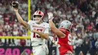 Indiana Hoosiers quarterback Fernando Mendoza (15) looks to pass around Ohio State Buckeyes defensive end Caden Curry (92) on Saturday, Dec. 6, 2025, during the Big Ten football championship at Lucas Oil Stadium in Indianapolis.
