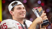 Indiana's Fernando Mendoza (15) holds the MVP trophy after the Indiana versus Ohio State Big Ten Championship football game at Lucas Oil Stadium on Saturday, Dec. 6, 2025.