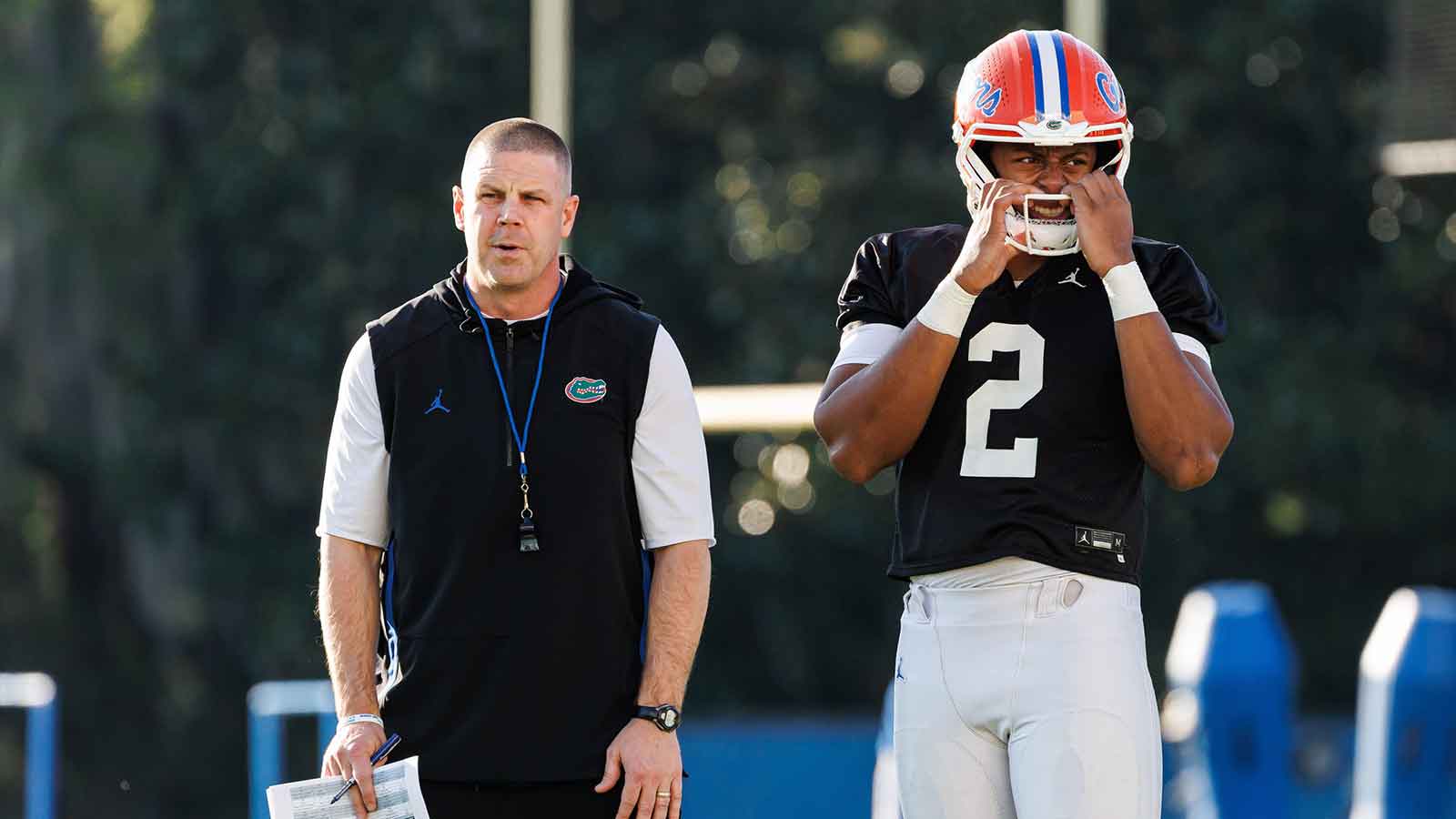 Florida Gators head coach Billy Napier and Florida Gators quarterback DJ Lagway (2) watch during spring football practice at Heavener Football Complex at the University of Florida in Gainesville, FL on Thursday, March 6, 2025.