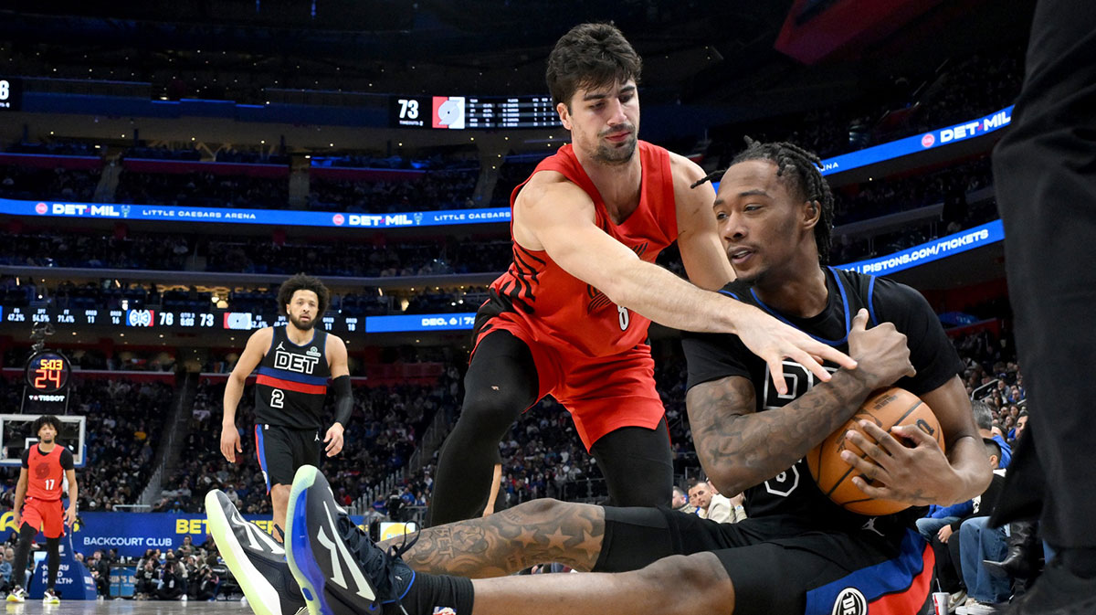 Detroit Pistons forward Ronald Holland II (5) tries to keep control of a loose ball while being pressured by Portland Trail Blazers forward Deni Avdija (8) in the third quarter at Little Caesars Arena.