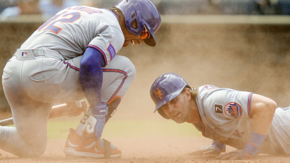 New York Mets shortstop Francisco Lindor (12) congratulates second baseman Jeff McNeil (1) after scoring a run during the ninth inning against the Kansas City Royals at Kauffman Stadium.