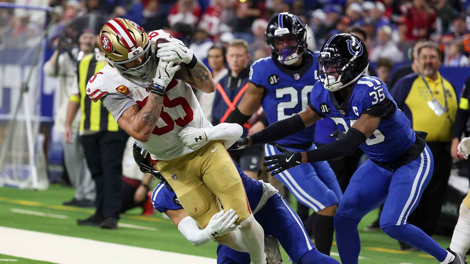 Indianapolis Colts safety Cam Bynum (0) tackles San Francisco 49ers tight end George Kittle (85) in the third quarter of the game at Lucas Oil Stadium.
