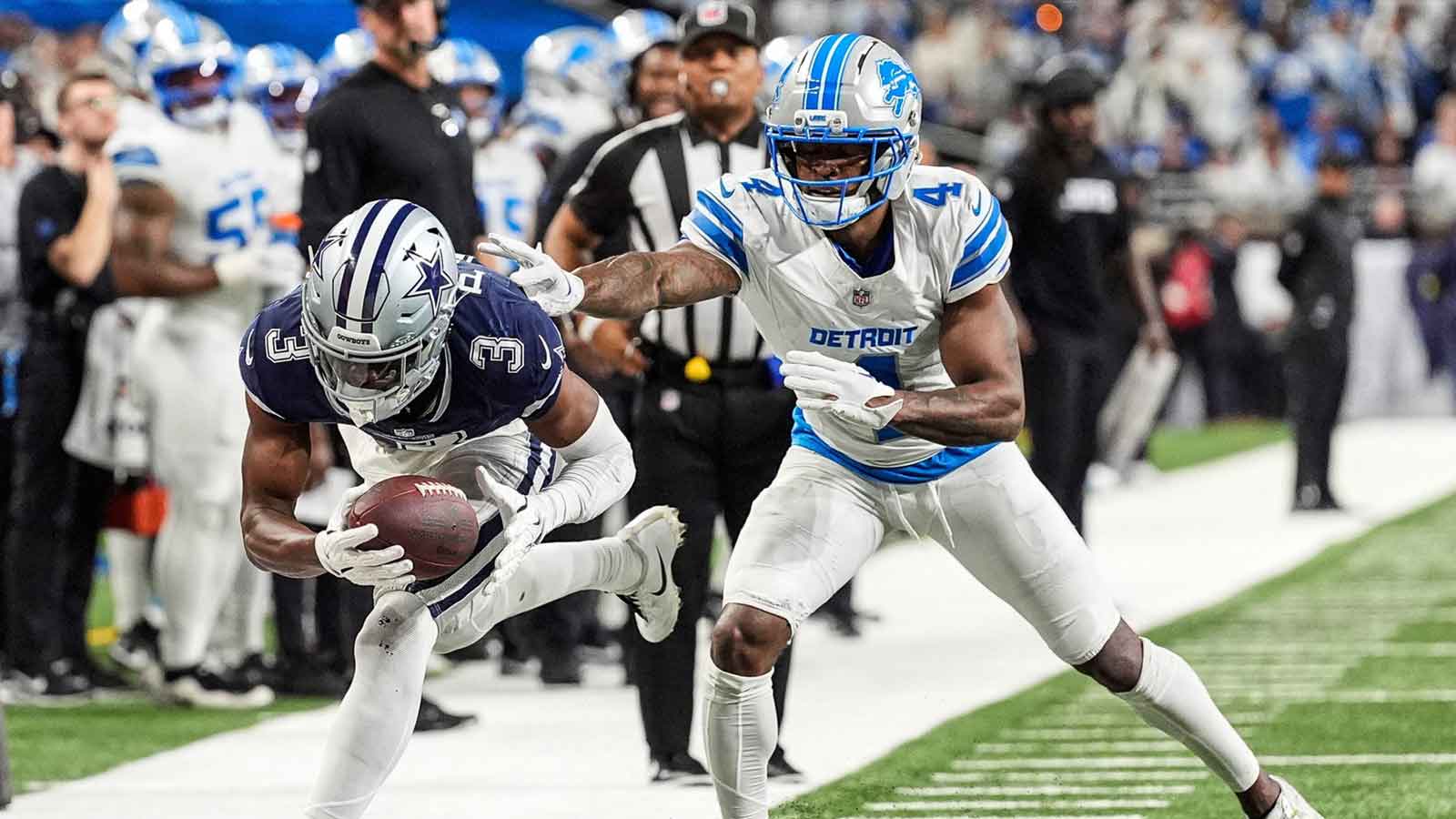 Detroit Lions cornerback D.J. Reed (4) pushes Dallas Cowboys wide receiver George Pickens (3) out of bound during the second half at Ford Field in Detroit on Thursday, Dec. 4, 2025.