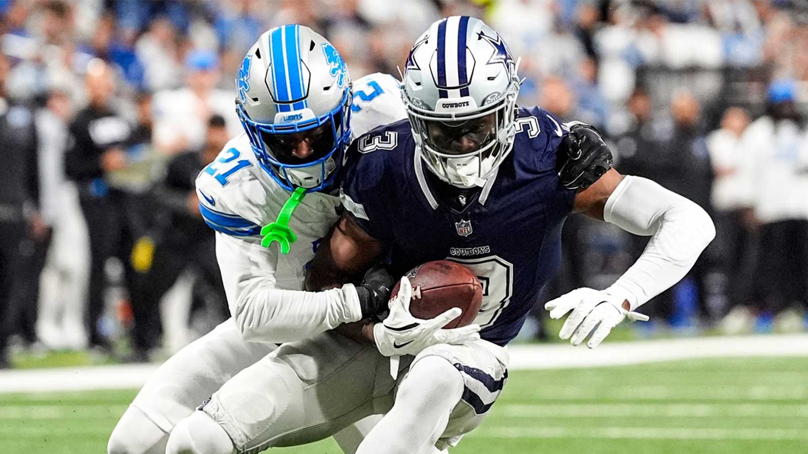 Detroit Lions cornerback Amik Robertson (21) tackles Dallas Cowboys wide receiver George Pickens (3) during the first half at Ford Field.
