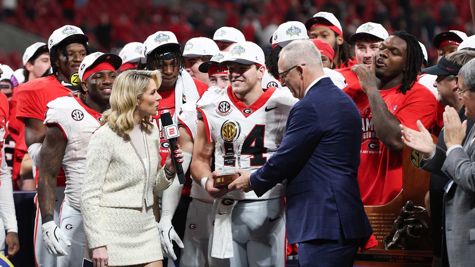 Georgia Bulldogs quarterback Gunner Stockton (14) is presented with the MVP trophy after the game against the Alabama Crimson Tide during the 2025 SEC Championship game at Mercedes-Benz Stadium.