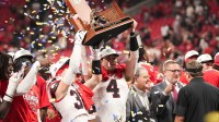 Georgia Bulldogs tight end Oscar Delp (4) and Georgia Bulldogs running back Cash Jones (32) lift the SEC Championship trophy after the game against the Alabama Crimson Tide during the 2025 SEC Championship game at Mercedes-Benz Stadium.