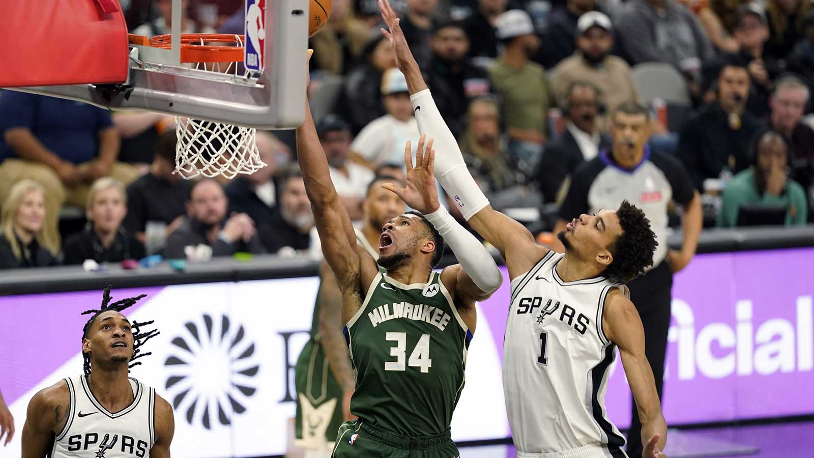 Milwaukee Bucks forward Giannis Antetokounmpo (34) drives to the basket past San Antonio Spurs center Victor Wembanyama (1) during the second half at Frost Bank Center.