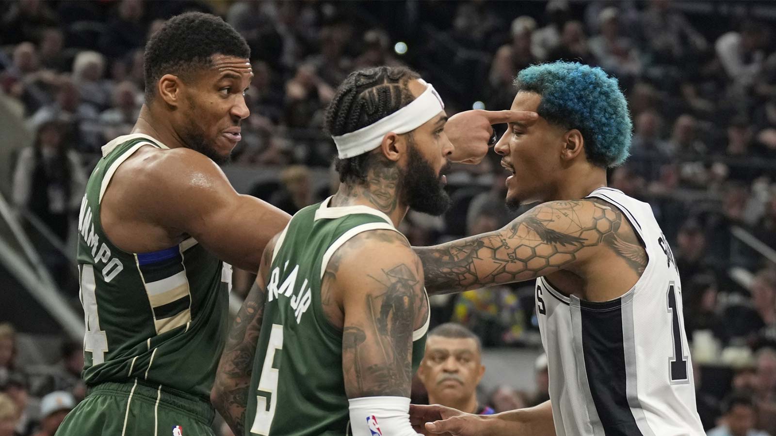 Milwaukee Bucks forward Giannis Antetokounmpo (34) is held back by San Antonio Spurs forward Jeremy Sochan (10) during the second half at Frost Bank Center. 