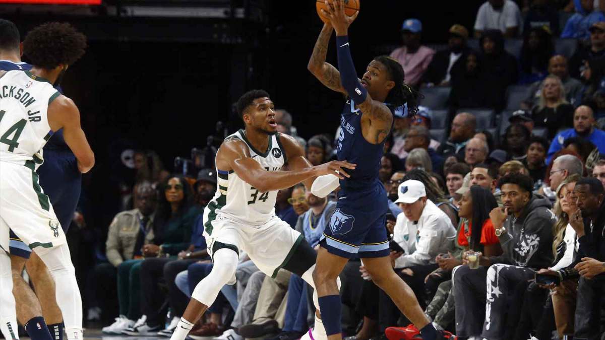 Memphis Grizzlies guard Ja Morant (12) passes the ball as Milwaukee Bucks forward Giannis Antetokounmpo (34) defends during the first half at FedExForum.