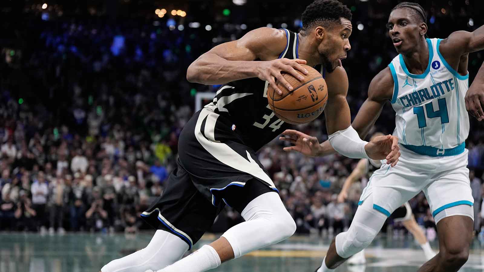Milwaukee Bucks forward Giannis Antetokounmpo (34) drives for the basket against Charlotte Hornets forward Moussa Diabate (14) during overtime at Fiserv Forum. 
