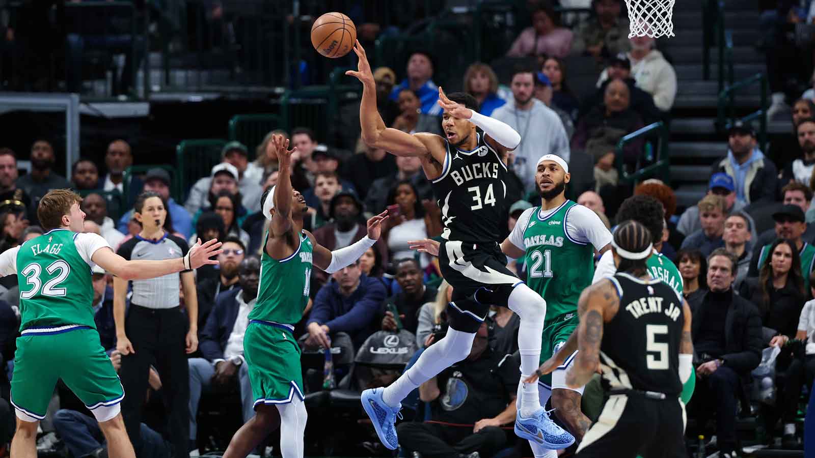 Milwaukee Bucks forward Giannis Antetokounmpo (34) passes the ball over Dallas Mavericks guard Brandon Williams (10) during the fourth quarter at American Airlines Center. 