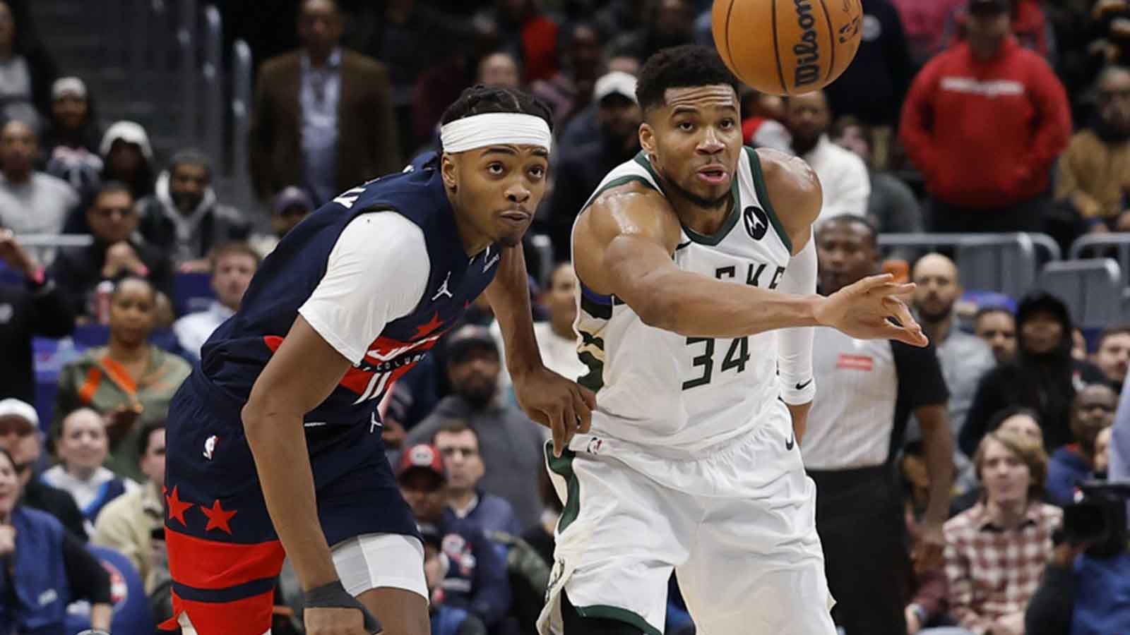 Washington Wizards guard Bilal Coulibaly (0) and Milwaukee Bucks forward Giannis Antetokounmpo (34) chase the ball after being knocked away by Coulibaly in the final seconds of the fourth quarter at Capital One Arena. 