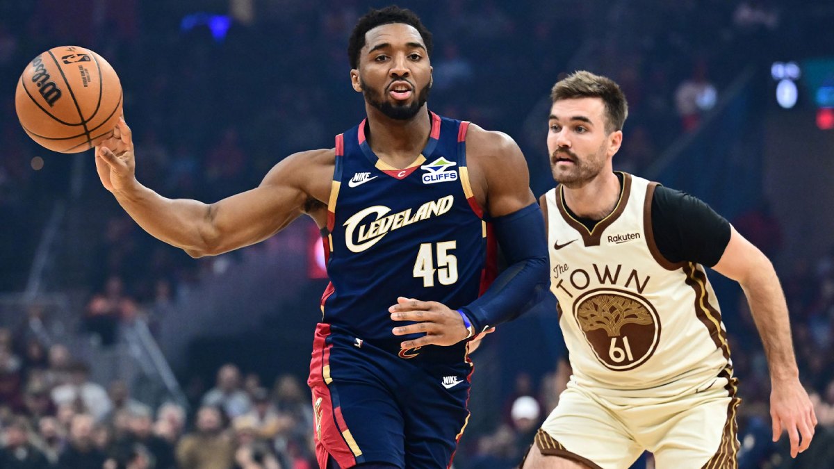 Cleveland Cavaliers guard Donovan Mitchell (45) passes as Golden State Warriors guard Pat Spencer (61) defends during the first half at Rocket Arena.