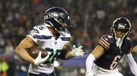 Seattle Seahawks running back Zach Charbonnet (26) runs for a gain as Chicago Bears cornerback Kyler Gordon (6) defends during the first quarter at Soldier Field.
