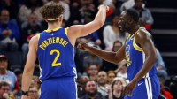 Golden State Warriors guard Brandin Podziemski (2) and forward Draymond Green (23) react during the first quarter against the Memphis Grizzlies at FedExForum.