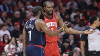 Houston Rockets forward Kevin Durant (7) talks with Los Angeles Clippers guard James Harden (1) during the third quarter at Toyota Center.
