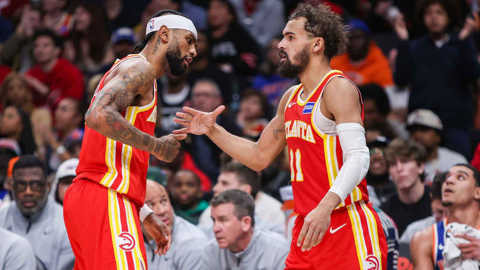 Hawks guard Trae Young (11) celebrates after a basket with guard Nickeil Alexander-Walker (7) against the New York Knicks in the third quarter at State Farm Arena