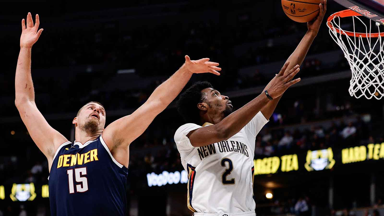 New Orleans Pelicans forward Herb Jones (2) drives to the basket against Denver Nuggets center Nikola Jokic (15) in the first quarter at Ball Arena. 