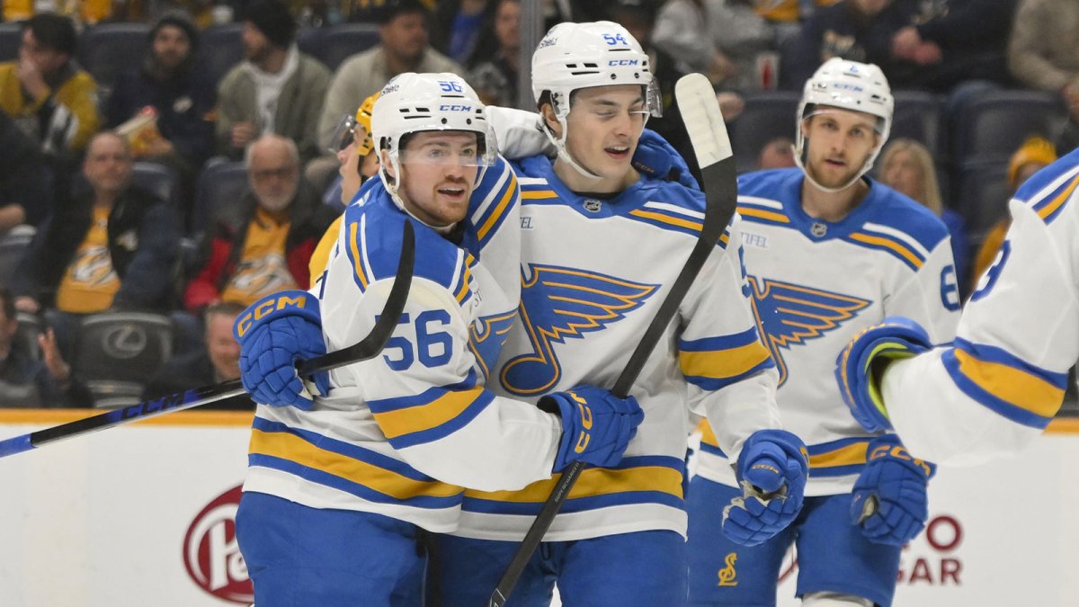 St. Louis Blues left wing Hugh McGing (56) celebrates his goal with right wing Dalibor Dvorsky (54) against the Nashville Predators during the second period at Bridgestone Arena.
