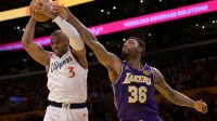 Los Angeles Clippers guard Chris Paul (3) beats Los Angeles Lakers guard Marcus Smart (36) to a rebound during the first half at Crypto.com Arena.